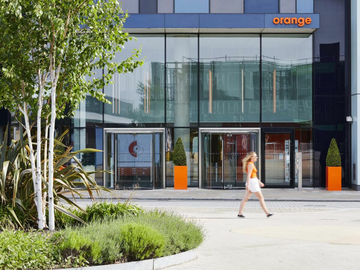 Women walking past the Orange building entrance