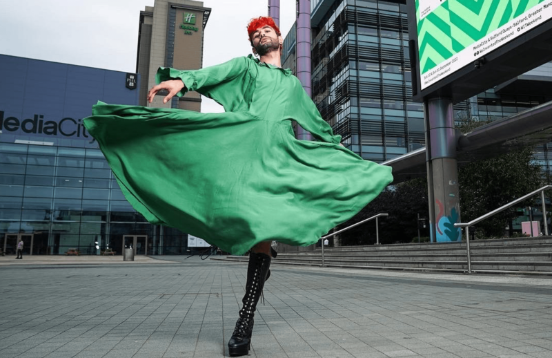 person dancing in front of the we invented the weekend sign