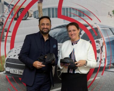 man and women in front of Vodafone signage