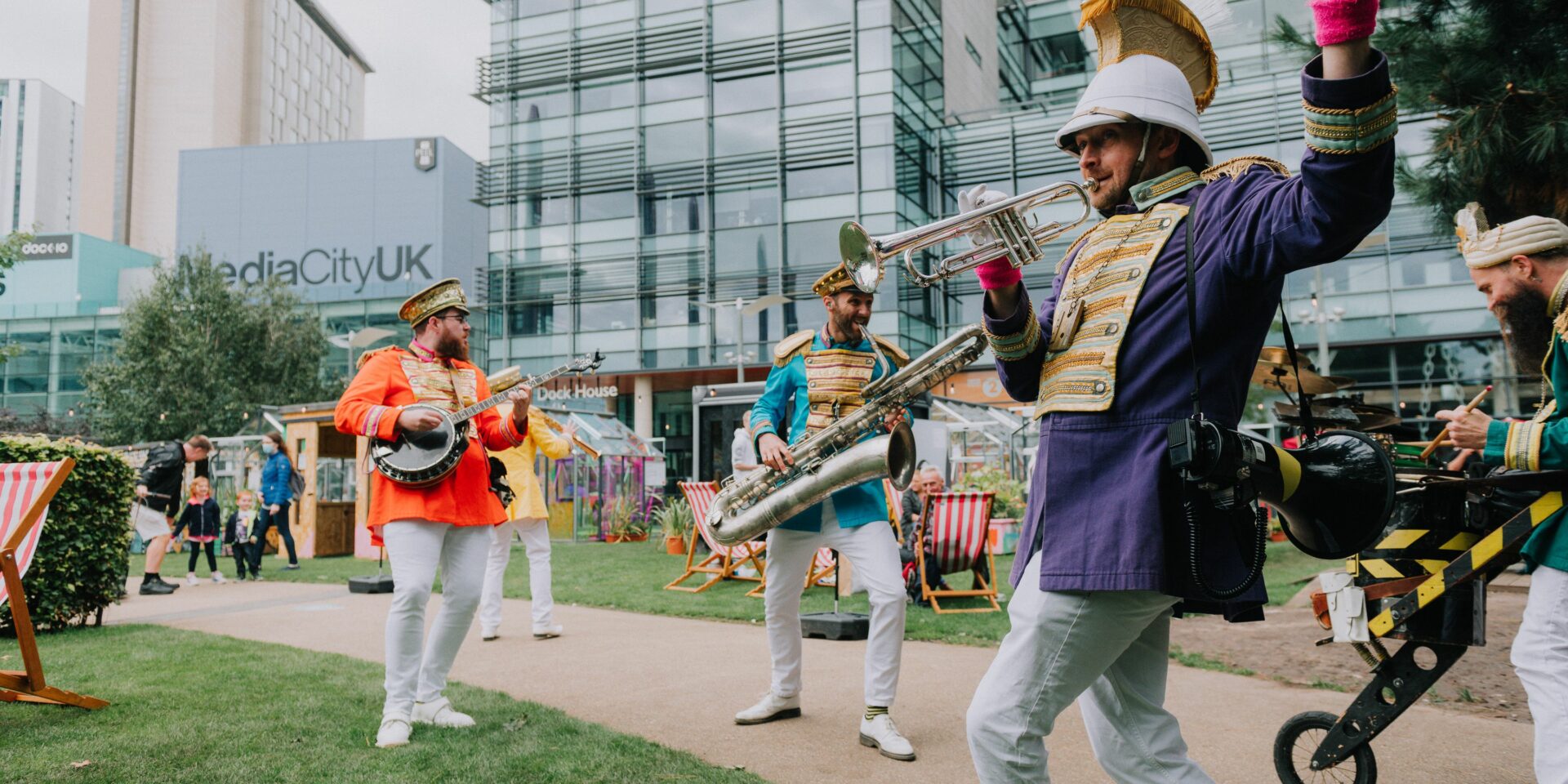 band members playing on the grass at mediacity